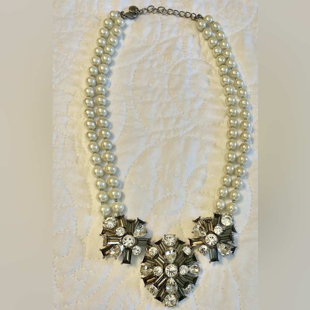 Pearl necklace with rhinestone pendants.